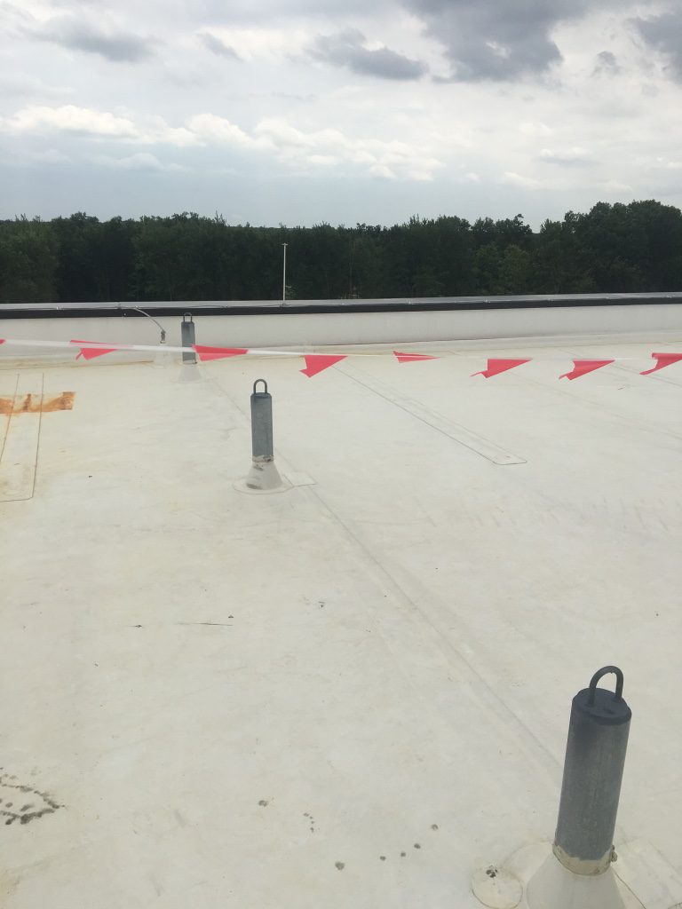 A parking lot with red and white markers on the ground.